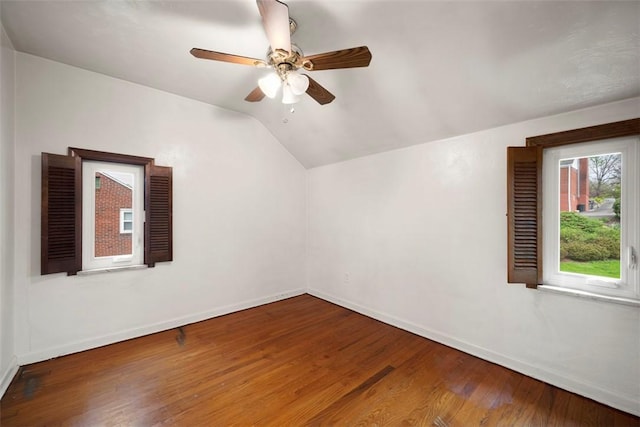 bonus room with wood finished floors, a ceiling fan, vaulted ceiling, and baseboards