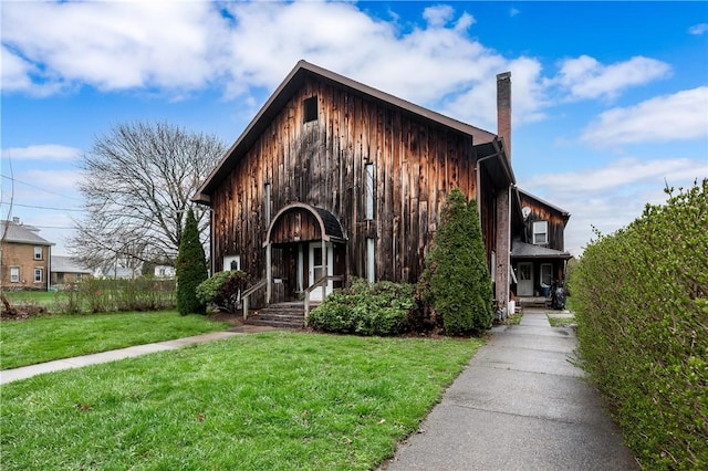 934 W W Rdg, Sharpsville, PA 16150 - view of front of home featuring a chimney, a front yard, and board and batten siding