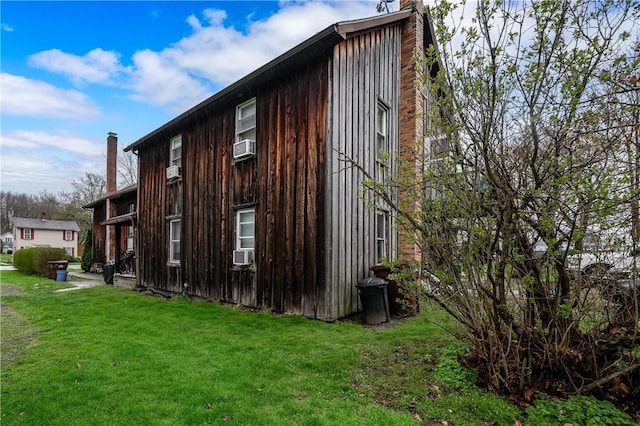 934 W W Rdg, Sharpsville, PA 16150 - view of side of home with a chimney, a lawn, cooling unit, and board and batten siding