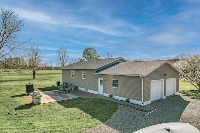 240 Hamburg Rd, Hempfield Twp Mer, PA 16125 - rear view of house featuring a detached garage, a shingled roof, and a yard