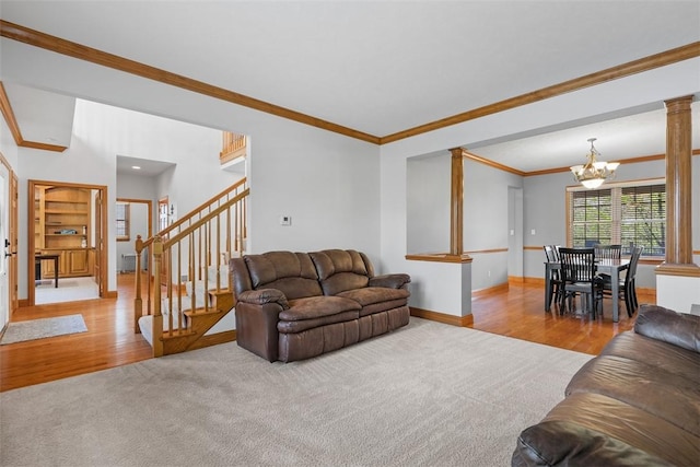 302 Castanea Dr, Cranberry Twp, PA 16066 - living room with baseboards, crown molding, wood finished floors, and a notable chandelier