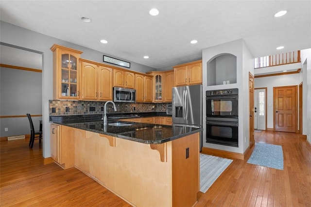 302 Castanea Dr, Cranberry Twp, PA 16066 - kitchen with a sink, stainless steel appliances, a peninsula, light wood-type flooring, and glass insert cabinets