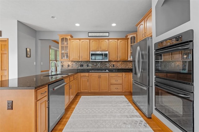 302 Castanea Dr, Cranberry Twp, PA 16066 - kitchen featuring appliances with stainless steel finishes, light wood-type flooring, a sink, a peninsula, and glass insert cabinets