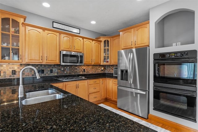 302 Castanea Dr, Cranberry Twp, PA 16066 - kitchen featuring appliances with stainless steel finishes, a sink, dark stone counters, backsplash, and glass insert cabinets