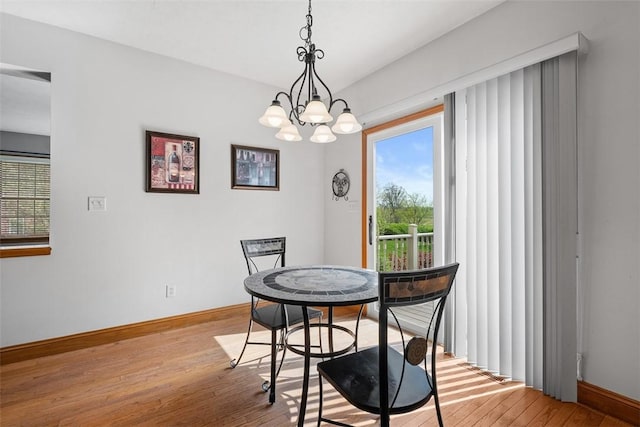 302 Castanea Dr, Cranberry Twp, PA 16066 - dining room with baseboards, light wood-style flooring, and a chandelier