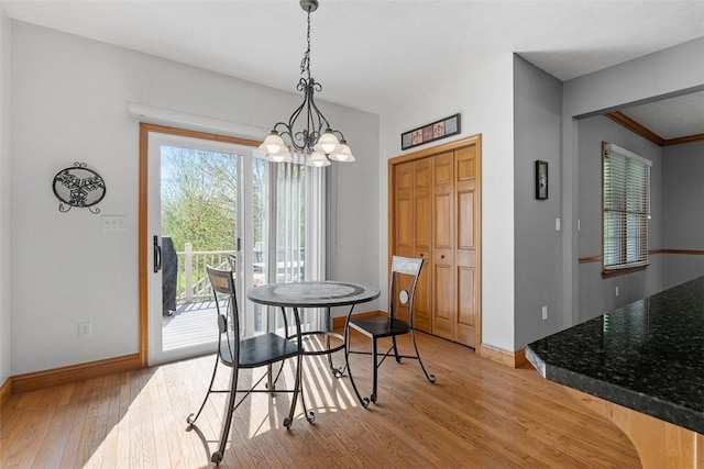 302 Castanea Dr, Cranberry Twp, PA 16066 - dining room with an inviting chandelier, light wood-style flooring, and baseboards
