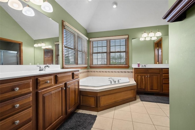 302 Castanea Dr, Cranberry Twp, PA 16066 - bathroom featuring a bath, tile patterned flooring, vaulted ceiling, two vanities, and a sink