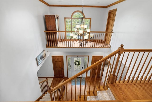 302 Castanea Dr, Cranberry Twp, PA 16066 - stairs with baseboards, ornamental molding, wood finished floors, and a notable chandelier