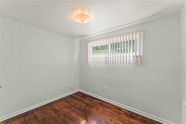 unfurnished room with wood finished floors and baseboards