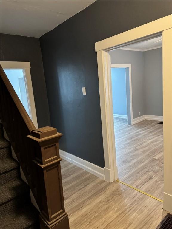 stairway with baseboards and wood finished floors