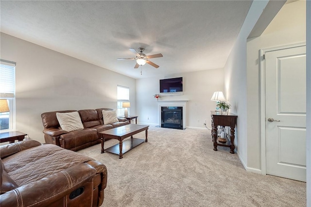 605 Saddle Ct, Moon/Crescent Twp, PA 15108 - living room with a fireplace with flush hearth, a ceiling fan, baseboards, and light carpet