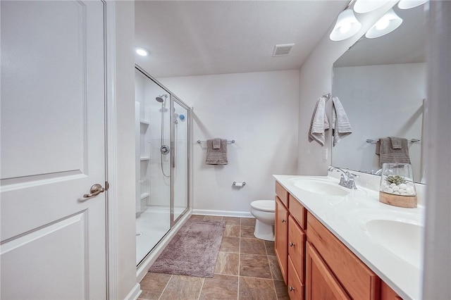 605 Saddle Ct, Moon/Crescent Twp, PA 15108 - bathroom featuring a shower stall, a sink, double vanity, visible vents, and toilet