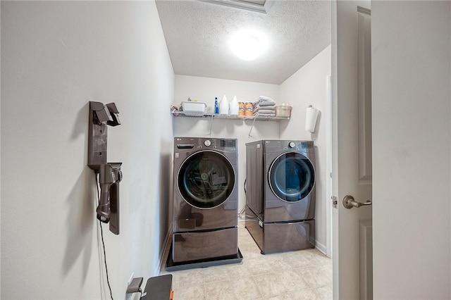 605 Saddle Ct, Moon/Crescent Twp, PA 15108 - clothes washing area with a textured ceiling, tile patterned flooring, washing machine and clothes dryer, and laundry area