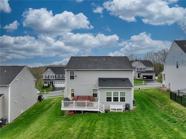 605 Saddle Ct, Moon/Crescent Twp, PA 15108 - rear view of house featuring fence, a residential view, a deck, a shingled roof, and a lawn