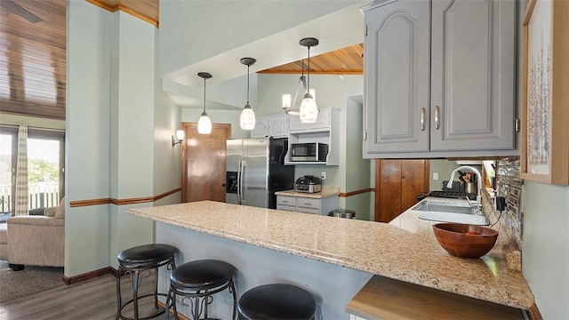 114 Silent Meadow Dr, Washington Twp Wml, PA 15632 - kitchen featuring a sink, stainless steel appliances, a peninsula, and a kitchen bar