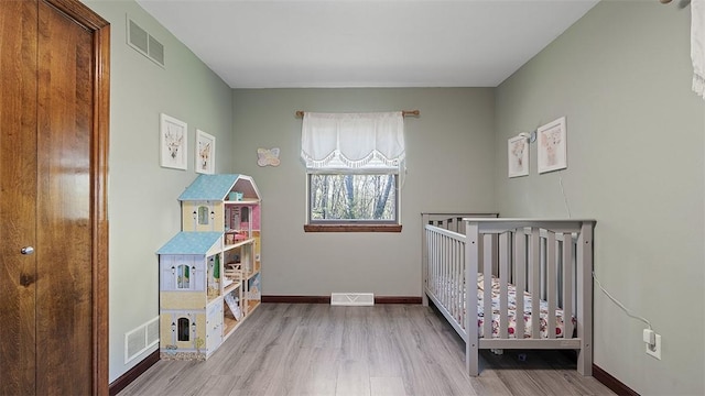 114 Silent Meadow Dr, Washington Twp Wml, PA 15632 - bedroom with a nursery area, baseboards, visible vents, and wood finished floors