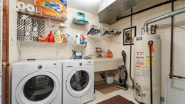 114 Silent Meadow Dr, Washington Twp Wml, PA 15632 - washroom featuring baseboards, laundry area, washer and clothes dryer, and water heater