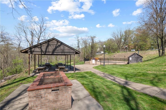surrounding community with fence, a gazebo, an outbuilding, a storage shed, and a lawn