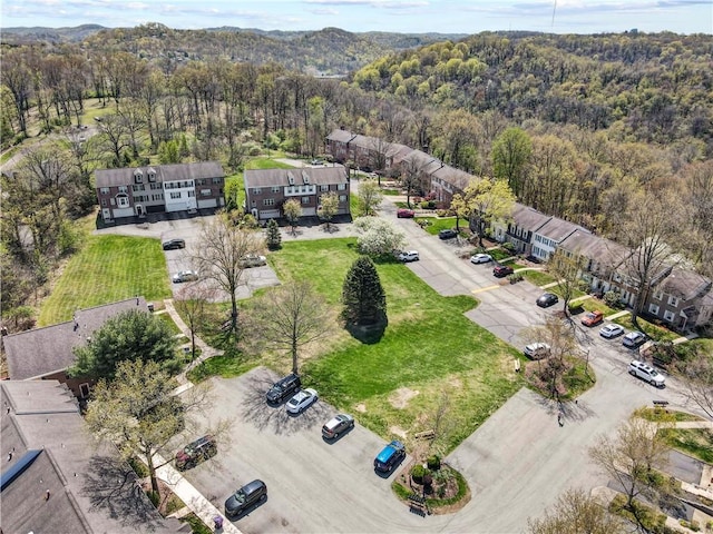 bird's eye view with a wooded view and a residential view