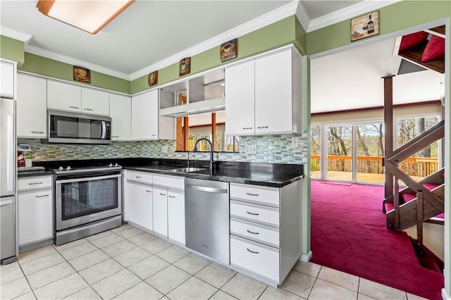 kitchen featuring a sink, stainless steel appliances, light tile patterned flooring, crown molding, and white cabinetry