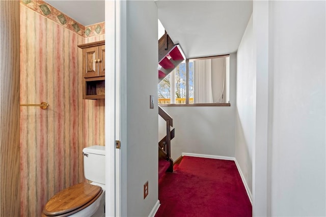 bathroom featuring toilet and baseboards
