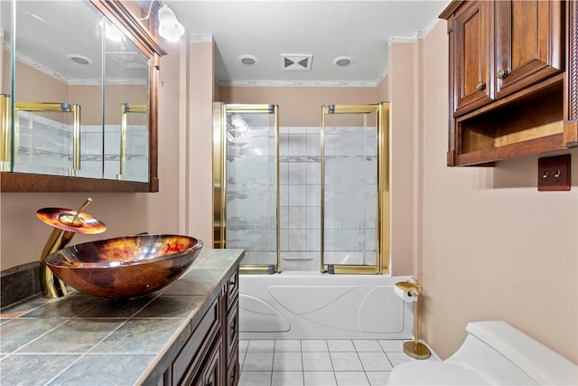 full bath featuring bath / shower combo with glass door, toilet, ornamental molding, and tile patterned flooring