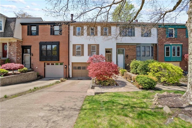 view of property featuring brick siding, driveway, and an attached garage