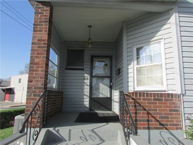entrance to property with covered porch and central AC