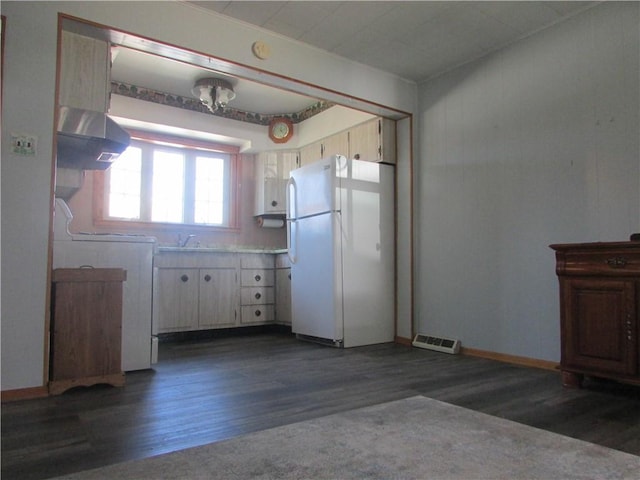 kitchen featuring freestanding refrigerator, light countertops, ventilation hood, visible vents, and dark wood-type flooring