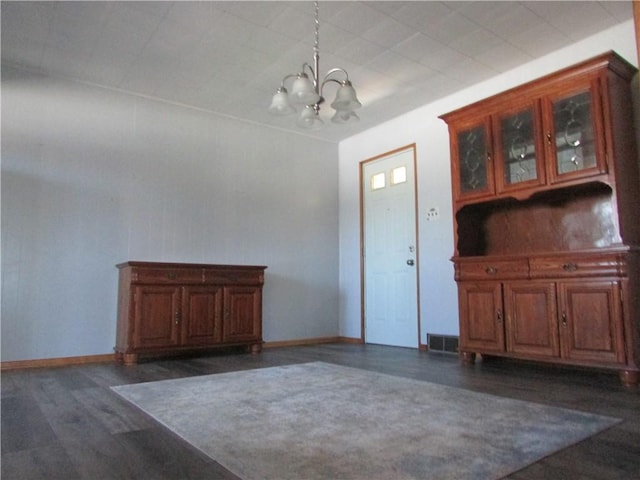 dining area with visible vents, a notable chandelier, wood finished floors, and baseboards