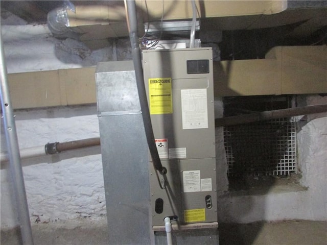 utility room featuring heating unit