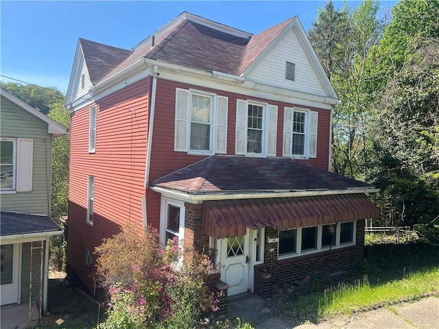 327 3rd St, Leechburg Boro, PA 15656 - view of front facade with brick siding and roof with shingles