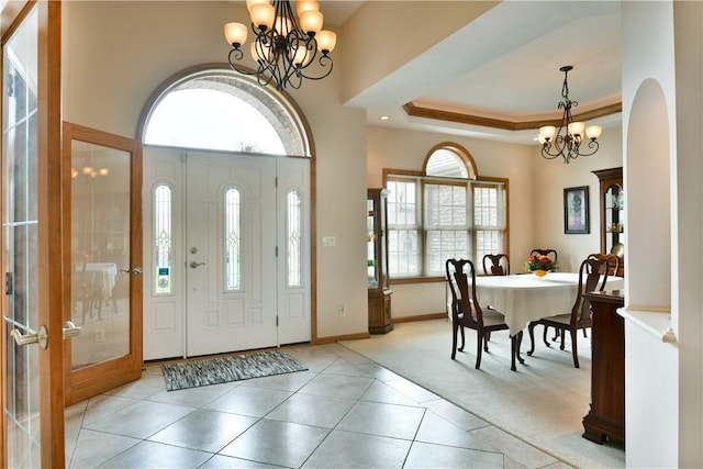 3461 Silver Ridge Ct, Hermitage, PA 16148 - foyer featuring light tile patterned flooring, an inviting chandelier, light colored carpet, and baseboards