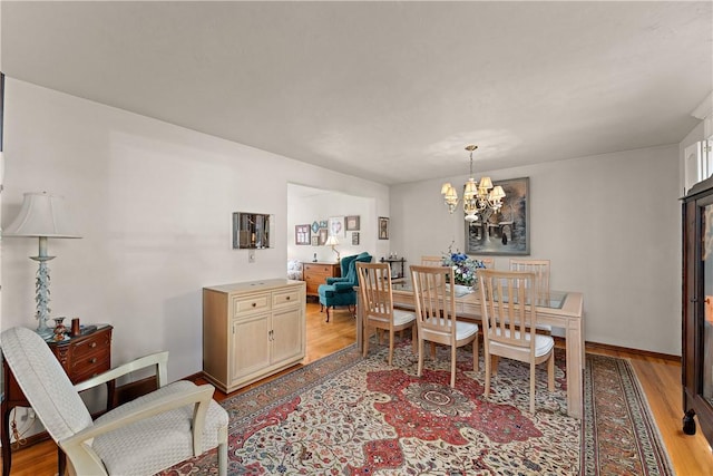 227 Gass Rd, Ross Twp, PA 15229 - dining area featuring a notable chandelier, baseboards, and light wood-type flooring