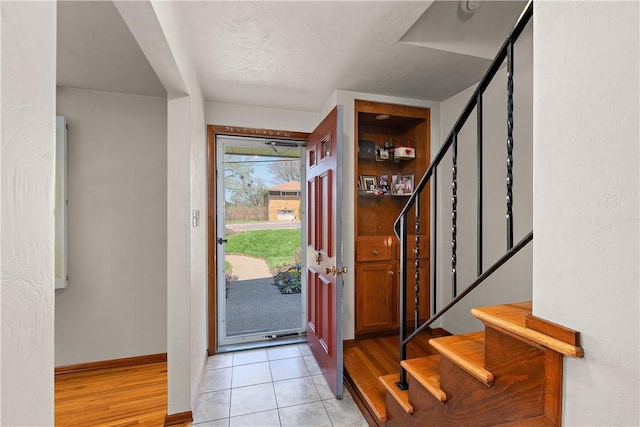 227 Gass Rd, Ross Twp, PA 15229 - entrance foyer featuring baseboards, stairway, and light tile patterned floors