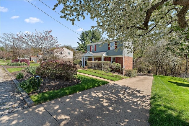 227 Gass Rd, Ross Twp, PA 15229 - view of front facade featuring concrete driveway, a front yard, and brick siding