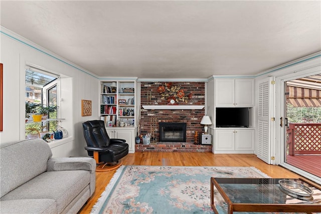 227 Gass Rd, Ross Twp, PA 15229 - living room featuring ornamental molding, a fireplace, built in shelves, and light wood-style floors