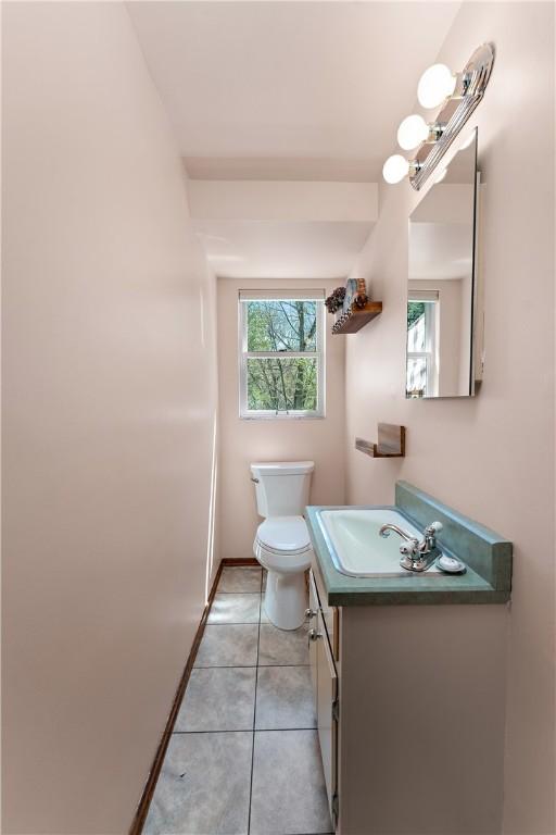 227 Gass Rd, Ross Twp, PA 15229 - half bath featuring toilet, vanity, tile patterned floors, and baseboards