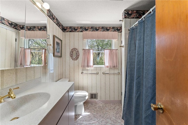 227 Gass Rd, Ross Twp, PA 15229 - full bathroom with a healthy amount of sunlight, toilet, visible vents, and tile patterned flooring