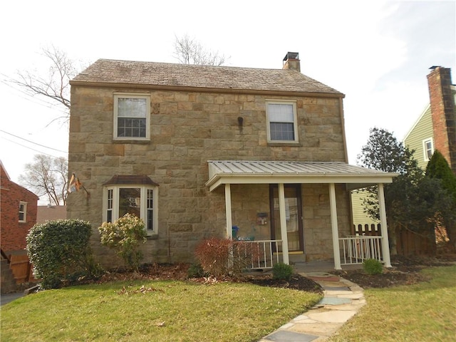 552 Crestline Dr, Baldwin Twp, PA 15234 - view of front facade featuring a porch, a front lawn, stone siding, and a standing seam roof