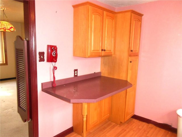 552 Crestline Dr, Baldwin Twp, PA 15234 - kitchen featuring dark countertops, baseboards, a kitchen breakfast bar, and light wood-type flooring