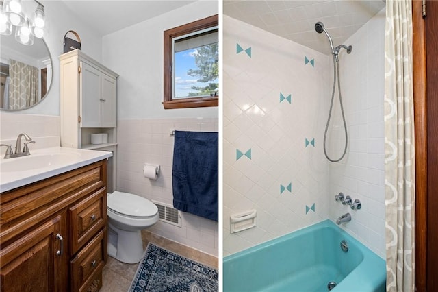full bathroom featuring visible vents, tile walls, vanity, tile patterned floors, and shower / tub combo with curtain