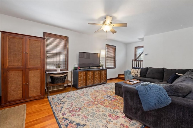 living room with ceiling fan and light wood-style floors