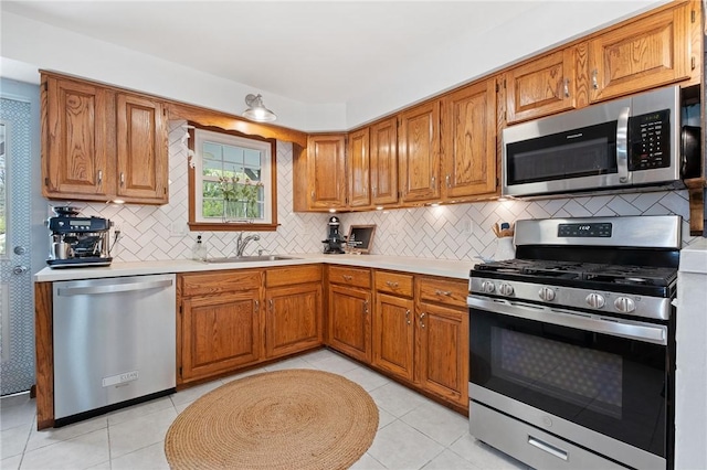 kitchen with brown cabinetry, light countertops, and stainless steel appliances