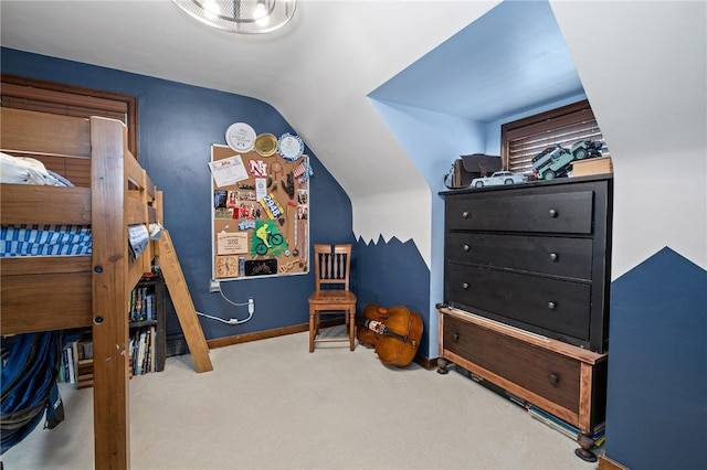 carpeted bedroom with lofted ceiling