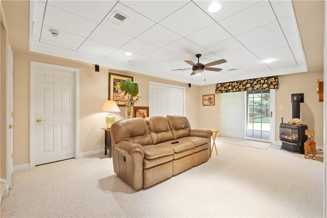 205 Prestonwood Ln, Peters Twp, PA 15317 - carpeted living room featuring a ceiling fan, visible vents, a wood stove, baseboards, and a drop ceiling