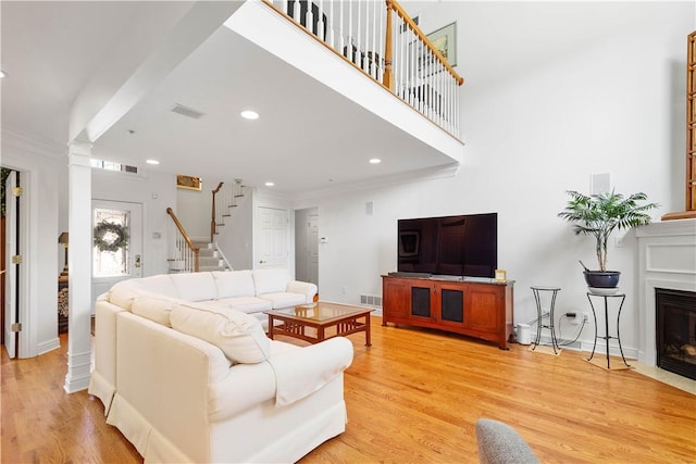 205 Prestonwood Ln, Peters Twp, PA 15317 - living area featuring a fireplace with flush hearth, light wood-type flooring, stairs, and visible vents