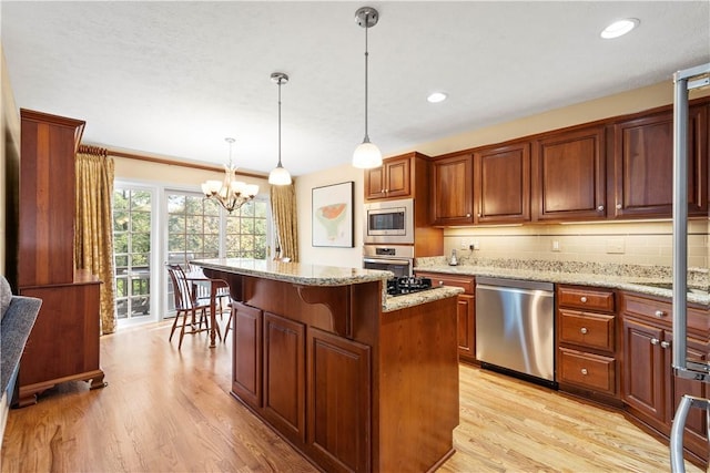 205 Prestonwood Ln, Peters Twp, PA 15317 - kitchen with tasteful backsplash, light stone countertops, light wood-type flooring, an inviting chandelier, and stainless steel appliances