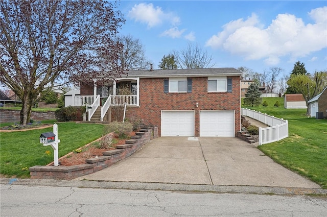 view of front of house with brick siding, a garage, a front lawn, and driveway
