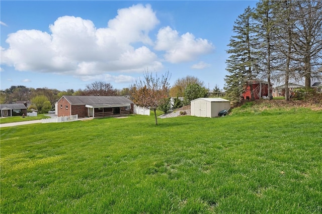 view of yard with a storage shed, fence, and an outdoor structure